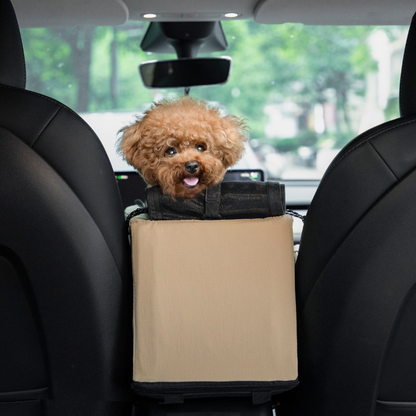 Small brown dog riding in beige center console pet car seat in car