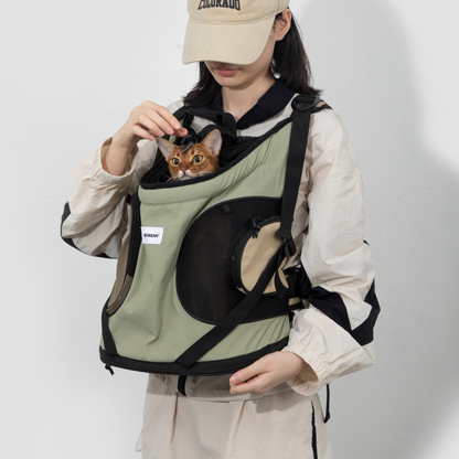 Cat peeking from sage front-facing carrier backpack with mesh side panel