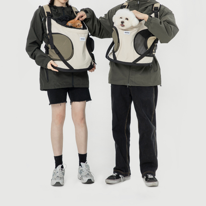 Two people wearing front-facing pet carrier backpacks with cat and dog
