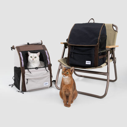 Cat beside white ergonomic anti-sag pet backpack and black carrier chair