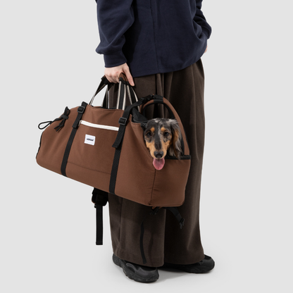 Owner holding brown baguette dog backpack carrier with dachshund peeking