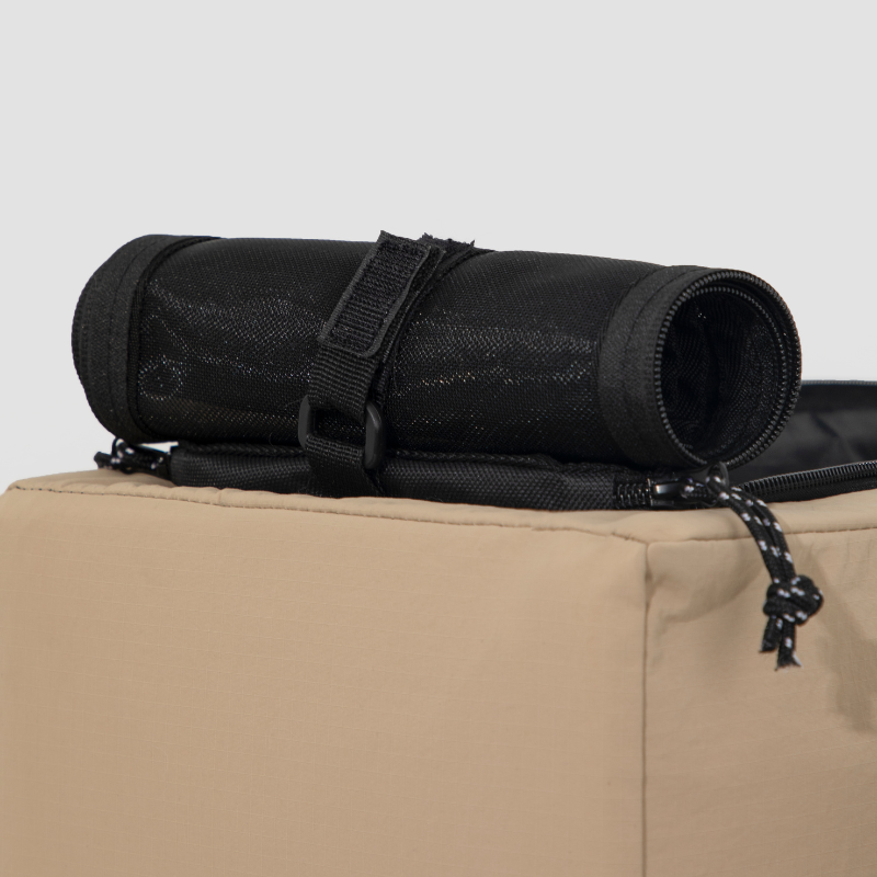 Rolled black mesh cover on beige center console pet car seat