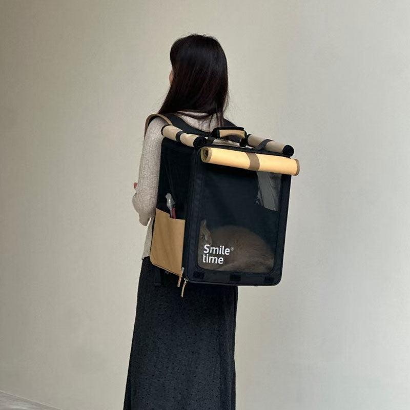 Black and beige roll-up cat carrier worn as a backpack