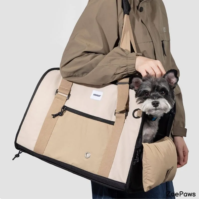 Small gray schnauzer peeking out of beige HDREAM pet carrier bag with shoulder strap